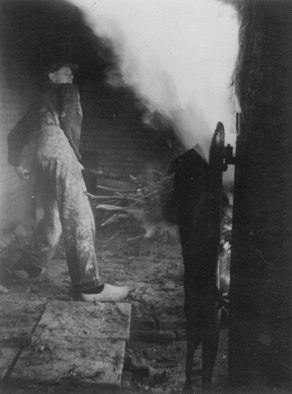 My father firing the wood kiln in Milsbeek
